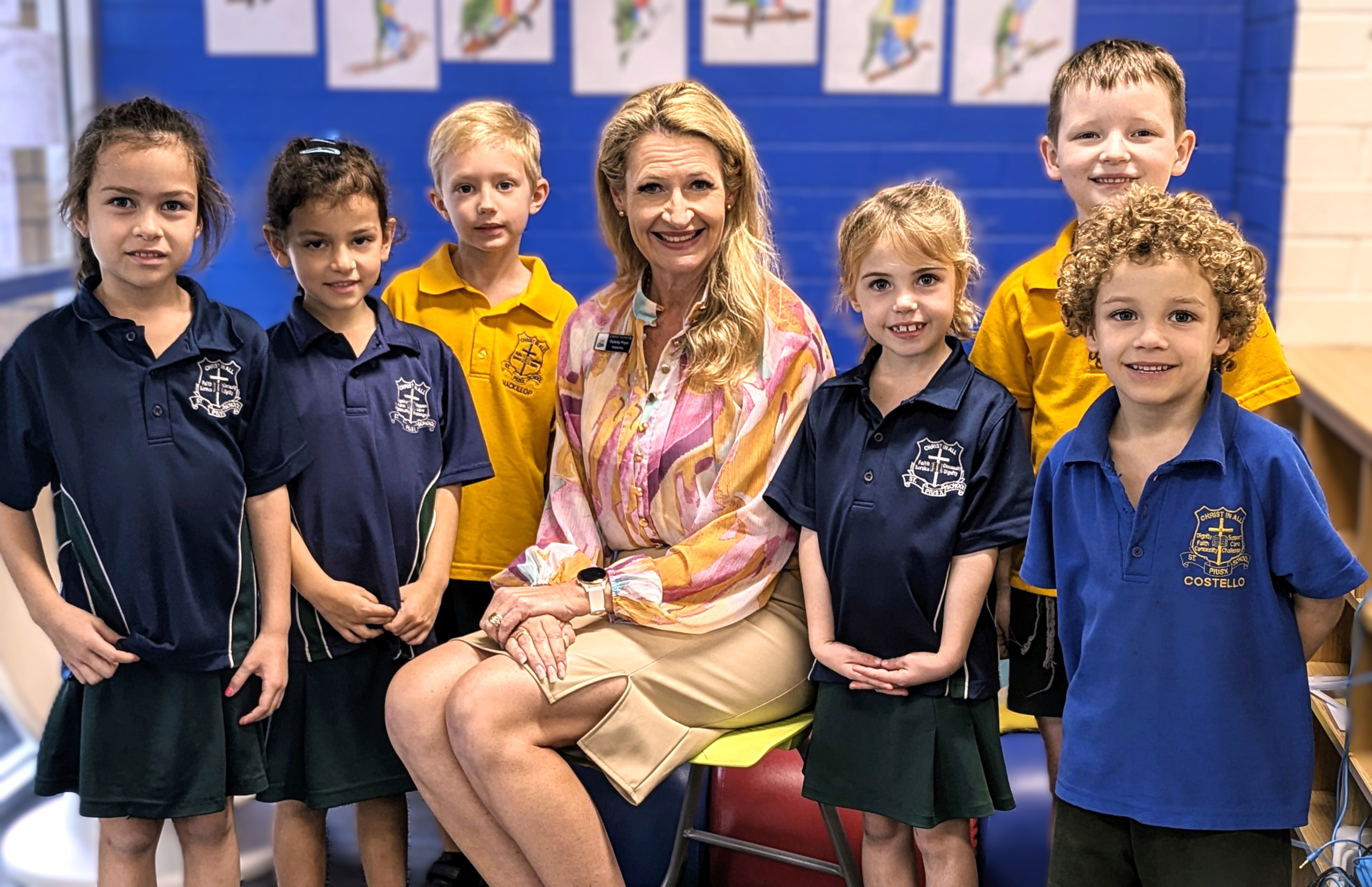 Mrs Felicity Pryer, Principal of St Pius X Primary School, seated with students in a classroom setting, representing approachable leadership, connection and a supportive school community