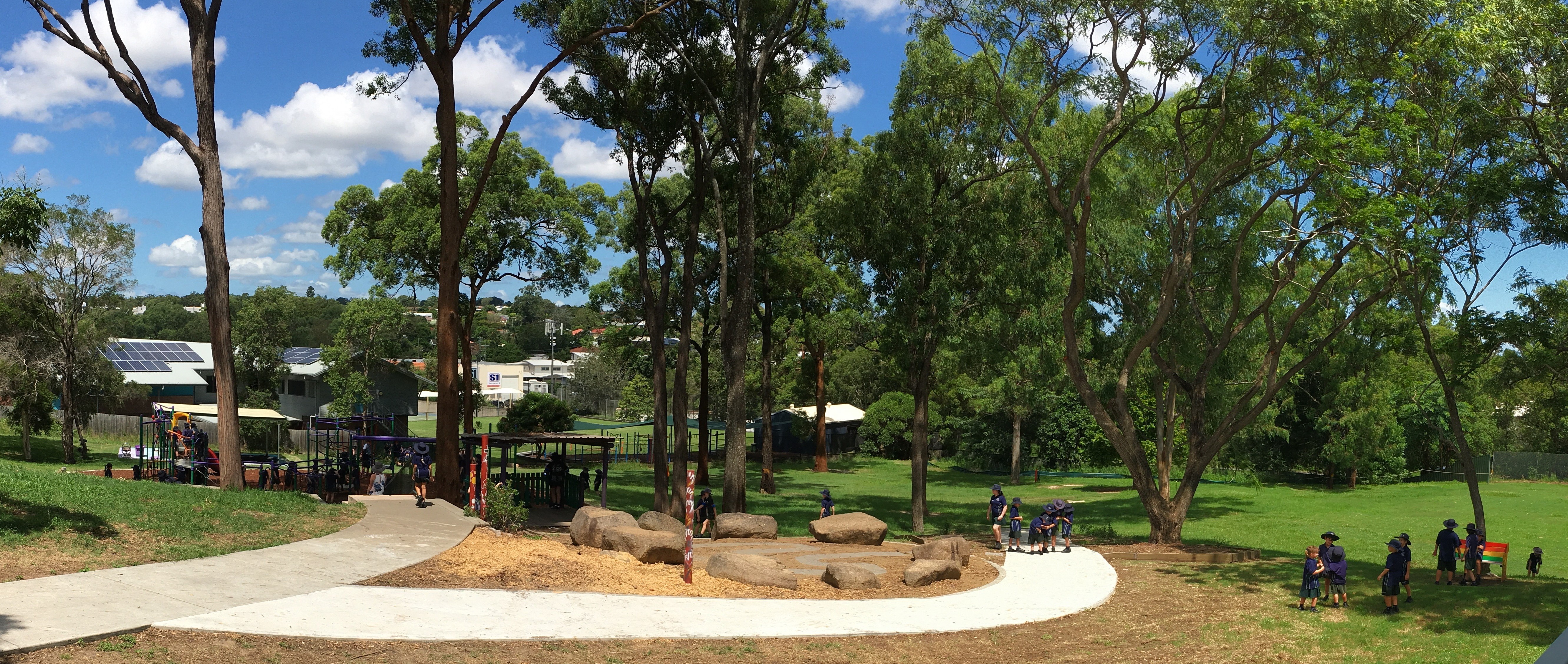 Students exploring a shaded outdoor play and learning area with natural elements, highlighting curiosity active play and connection with the environment at St Pius X Primary School