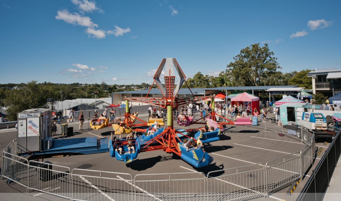 Carnival ride set up on school grounds, highlighting community events and student enjoyment