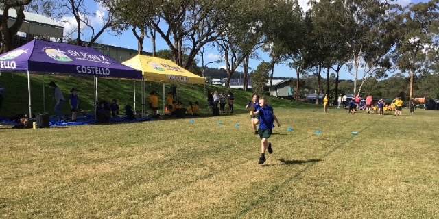 Student participating in an athletics running activity on the school oval, highlighting fitness teamwork and active participation at St Pius X Primary School