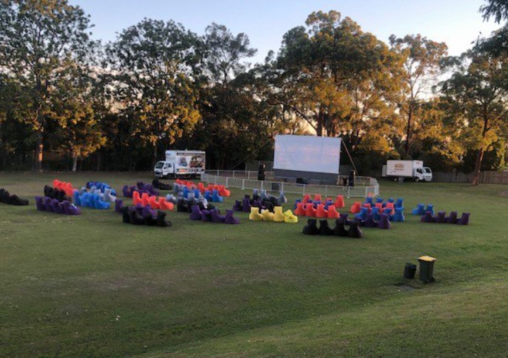 Outdoor movie setup with seating on the oval, highlighting community gathering and shared school events